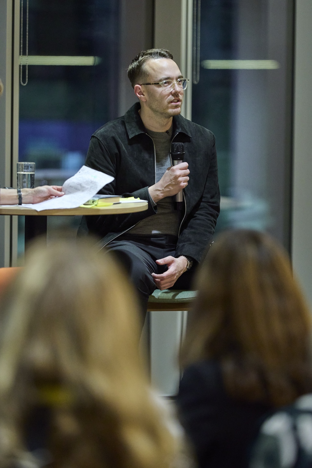 David Challen speaking with members of an audience in the foreground