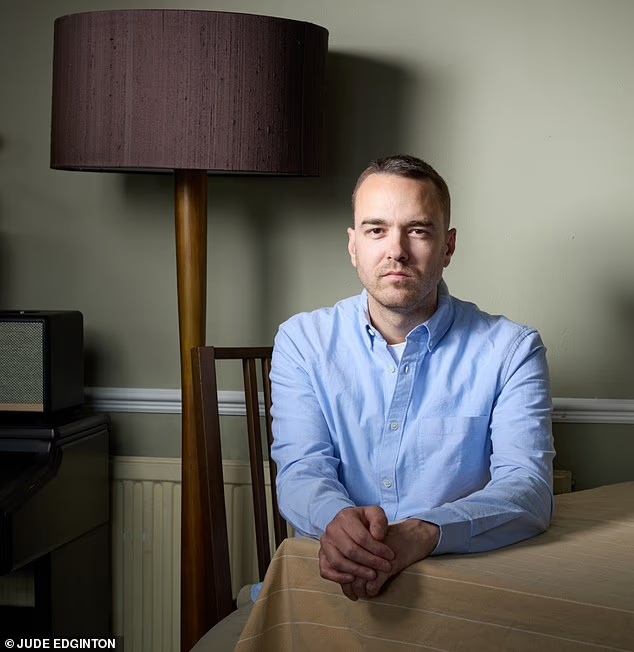 David Challen seated at a table at home