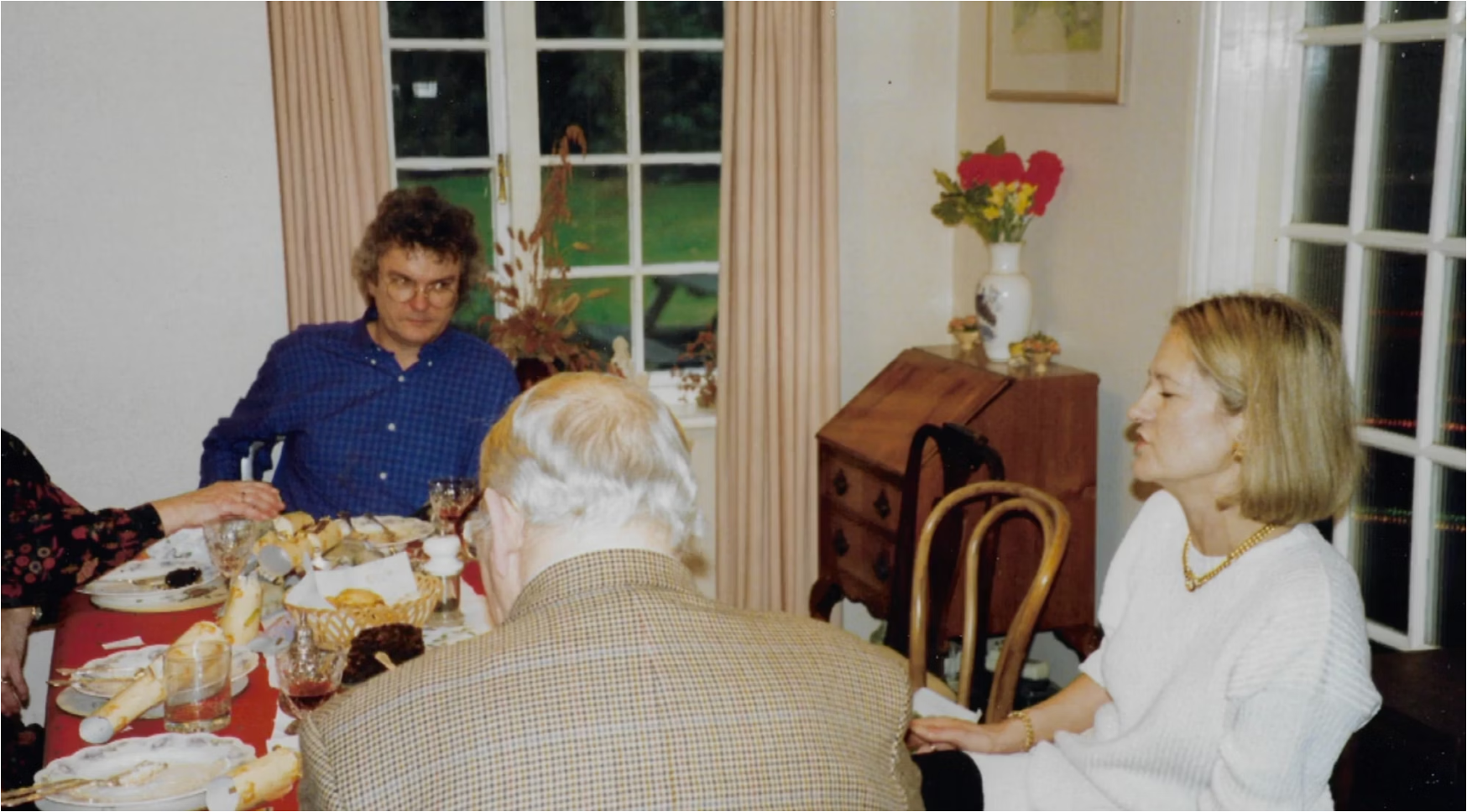 An archival family photograph taken around the dining table in the Challen home
